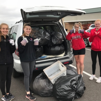 Students with garage bags